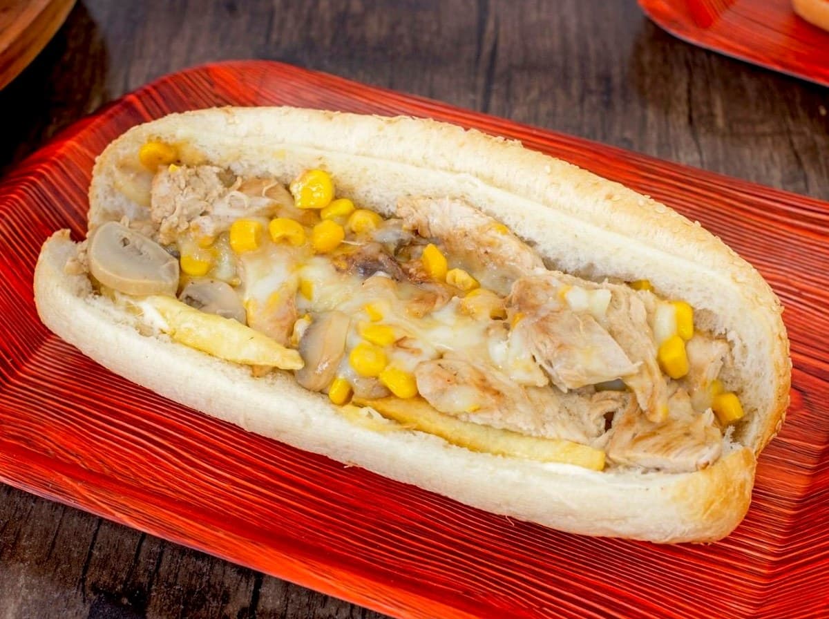 A Friend Hub signature hot roll filled with marinated chicken and chips