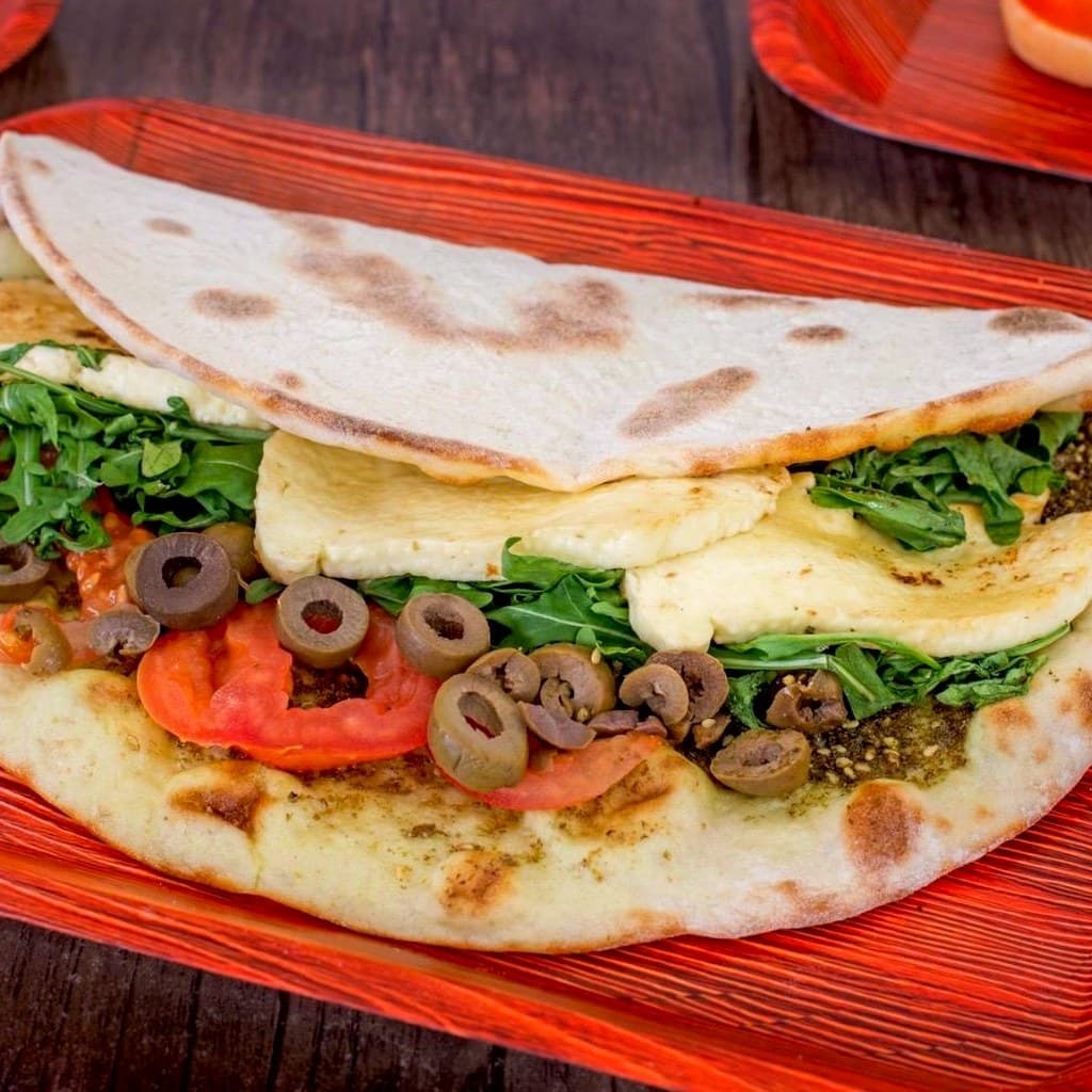 A za'atar halloumi wrap with tomato, rocket and olives